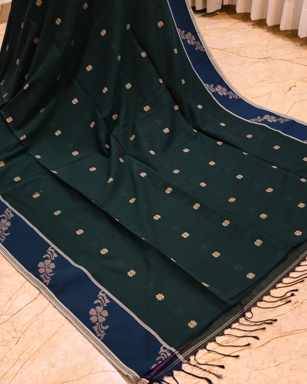 Green Bengal cotton saree with navy floral border and tassels