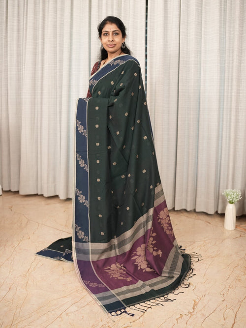 Model wearing Aaranyaa deep green Bengal cotton saree