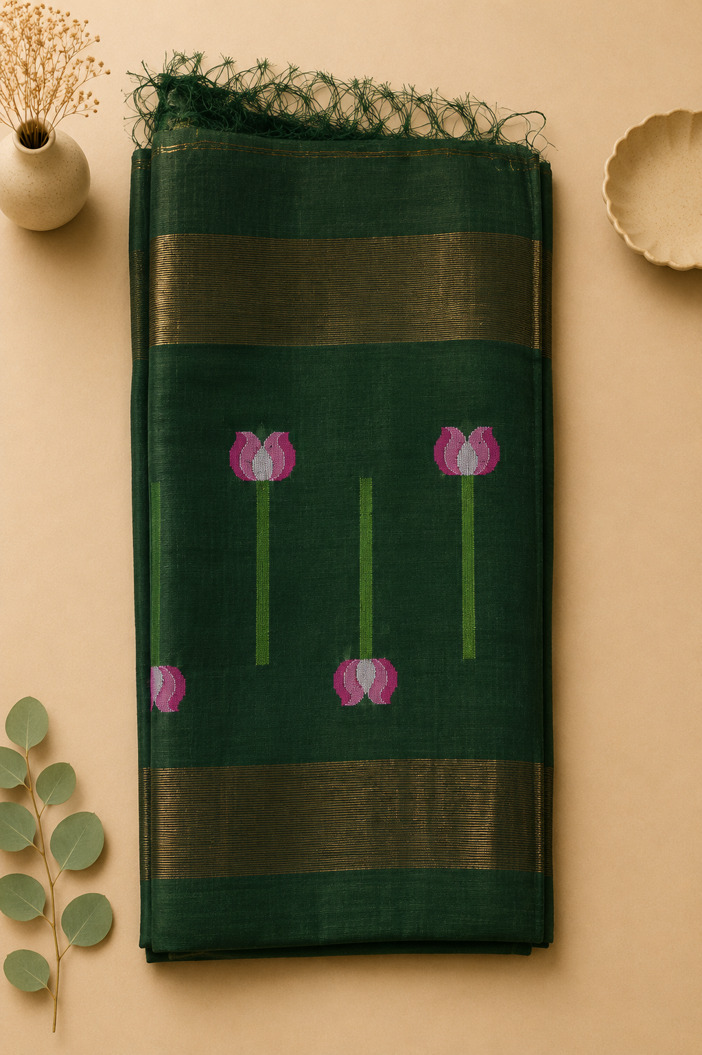 Close-up of dark green Matka silk Jamdani saree with woven pink lotus motifs and broad gold zari border – Nayikaa