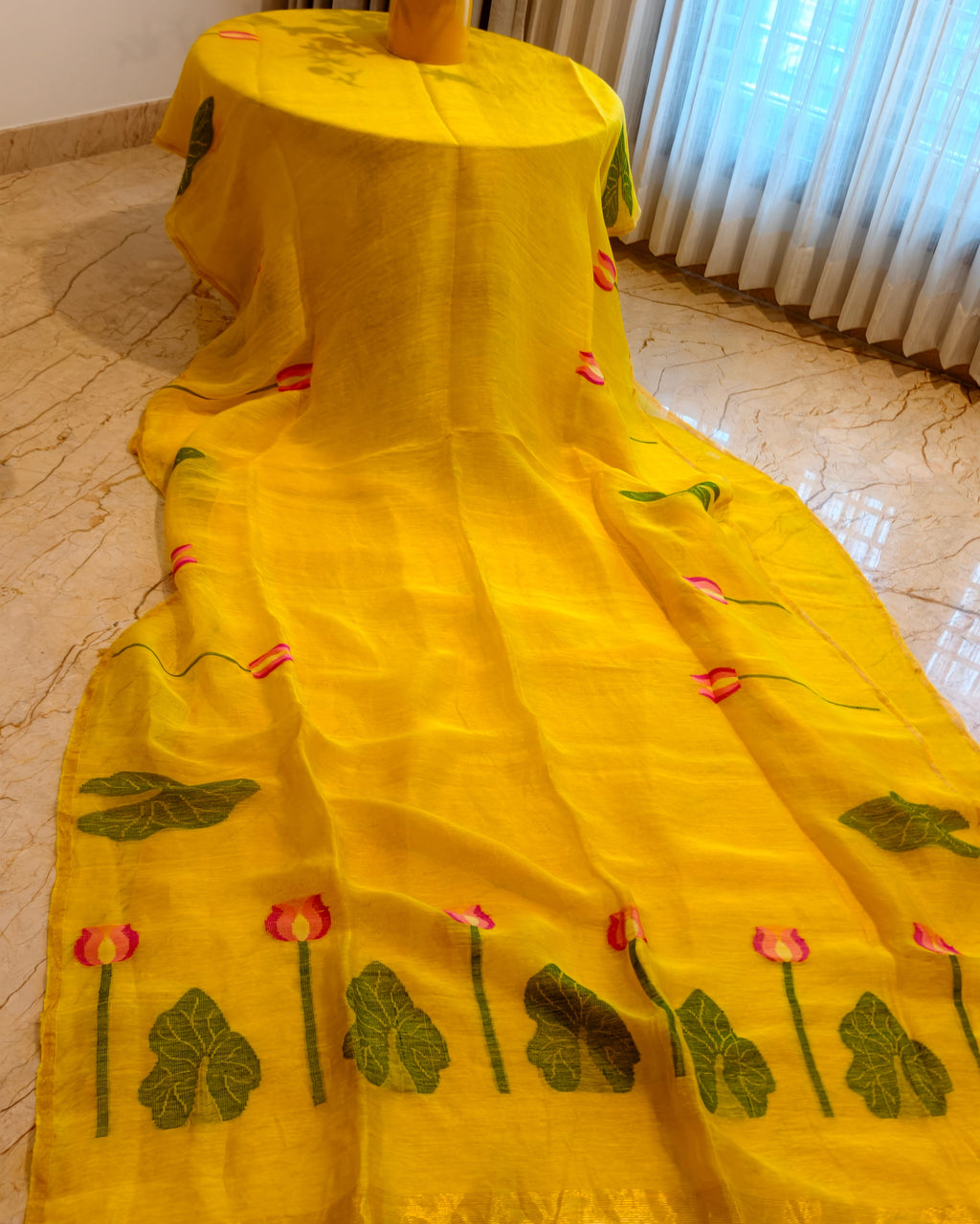 Full view of Kanaka Padma yellow Matka silk Jamdani saree with woven pink lotus and green leaf motifs – Nayikaa