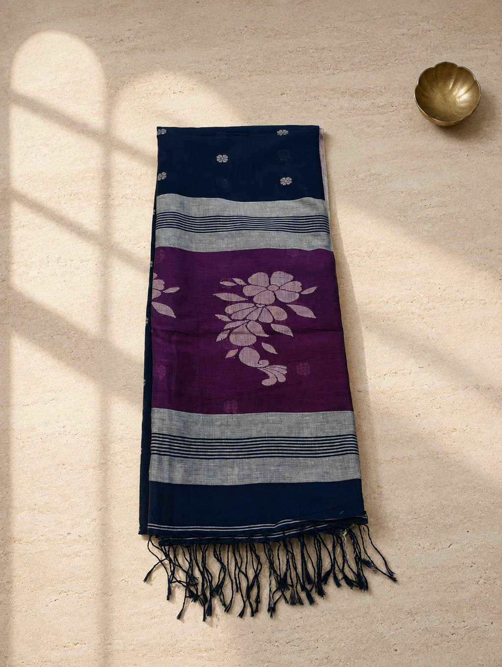 Folded Neelanjana navy Bengal cotton saree with magenta floral pallu