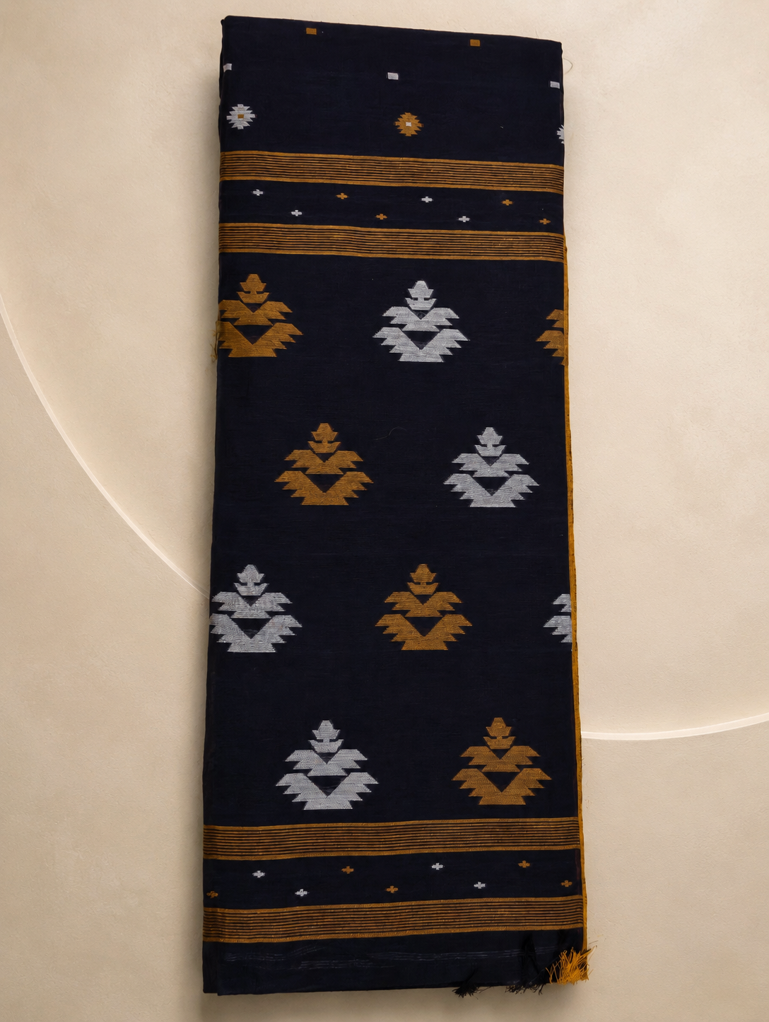 Folded Nishitha navy blue Bengal cotton saree with mustard and white pallu motifs
