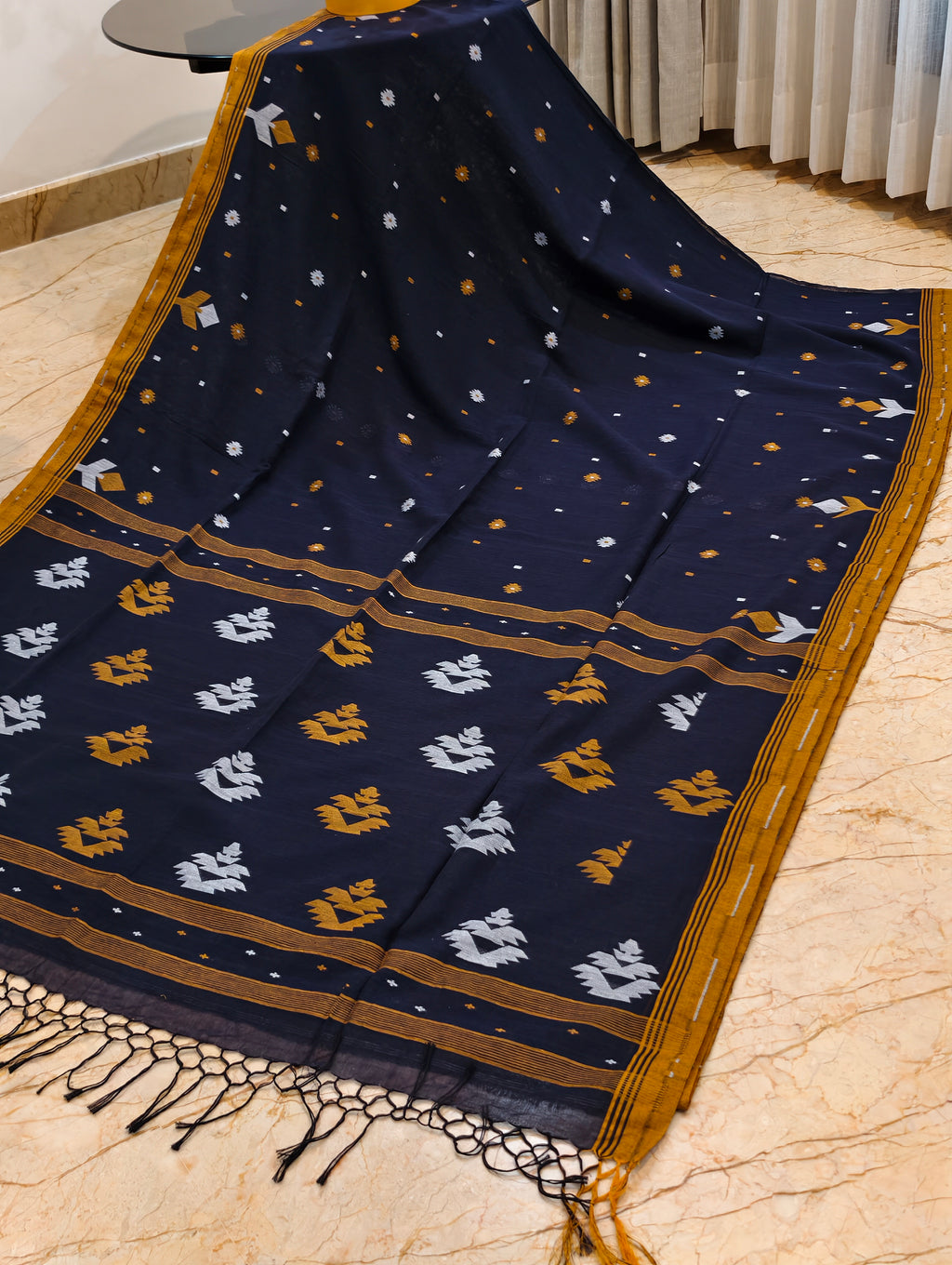 Navy blue Bengal cotton saree displayed with mustard border and contrasting woven pallu