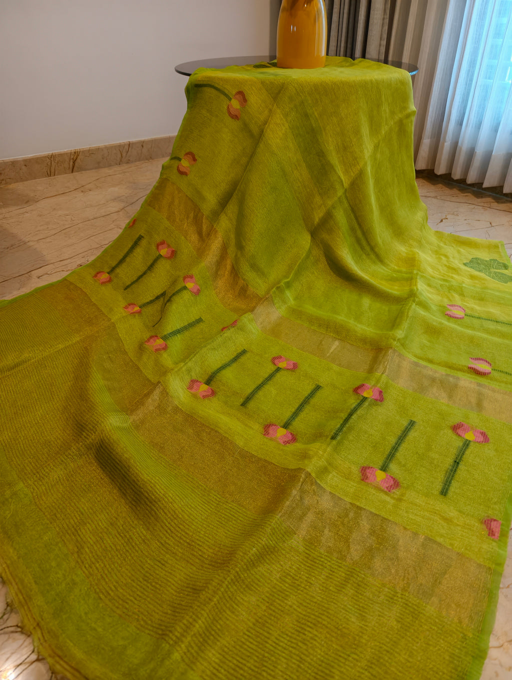 Close-up of parrot green linen silk saree with woven floral pallu and gold zari – Nayikaa