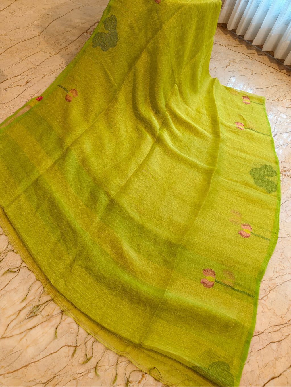 Open parrot green linen silk saree showing woven floral and leaf motifs – Nayikaa