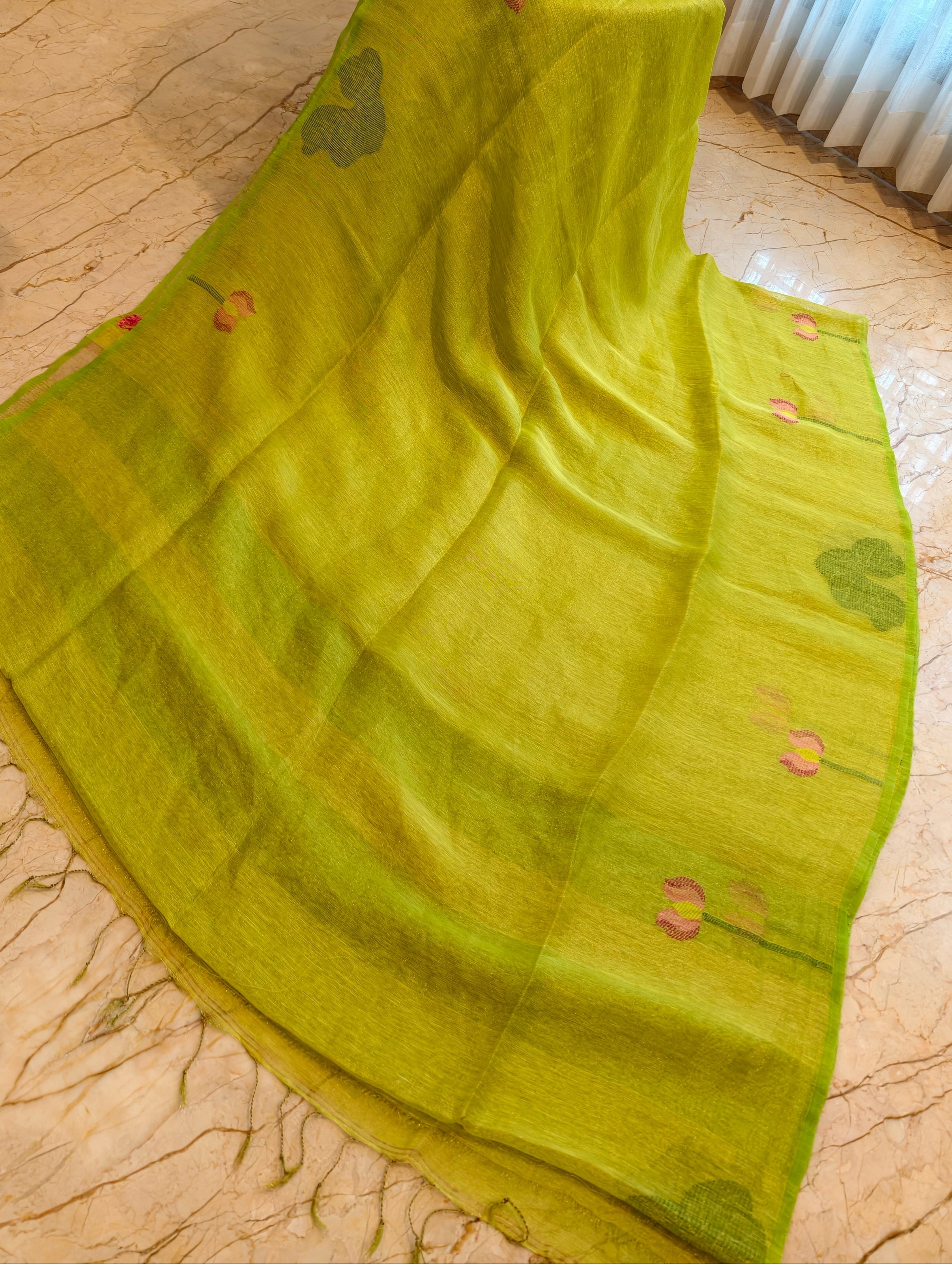 Open parrot green linen silk saree showing woven floral and leaf motifs – Nayikaa