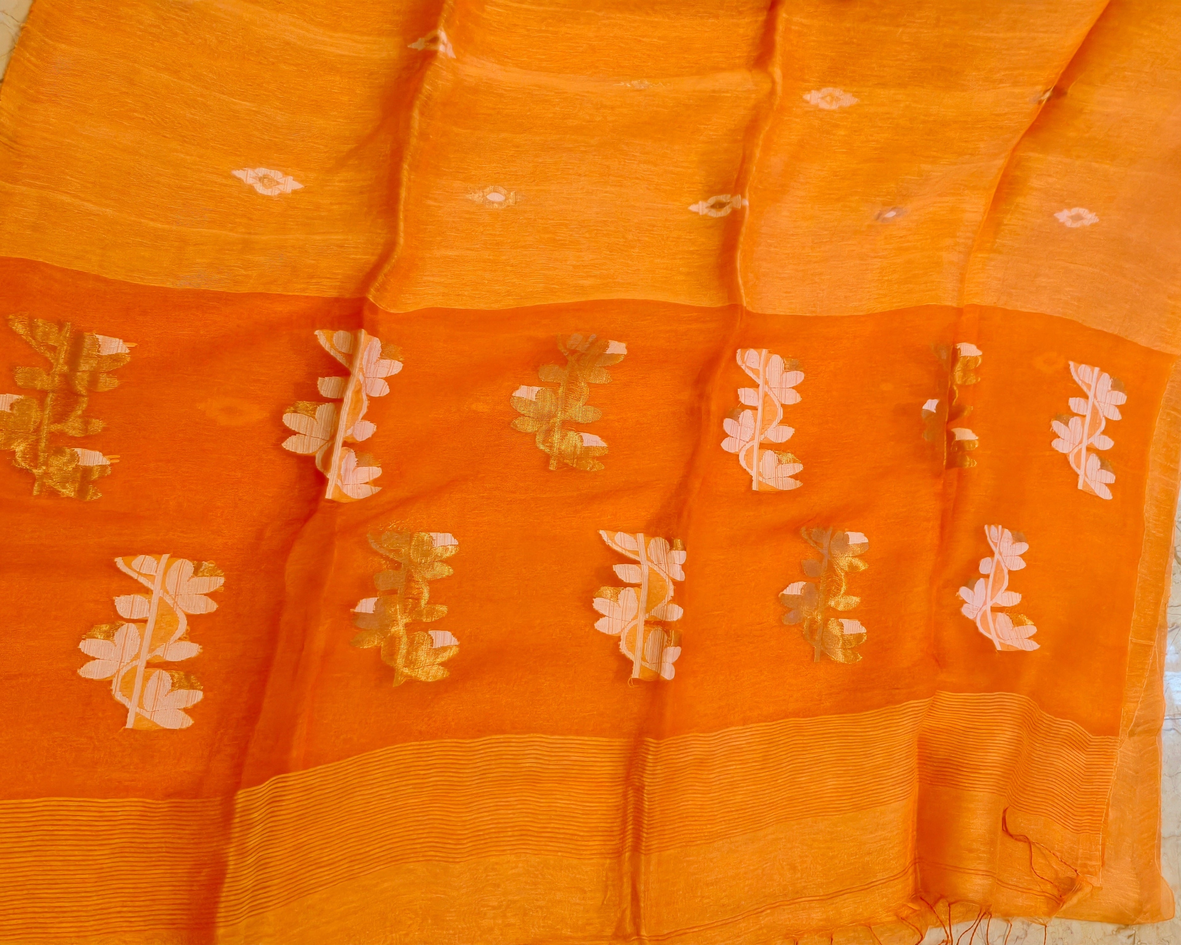 Orange Matka Muslin Jamdani saree close-up with white and gold woven motifs