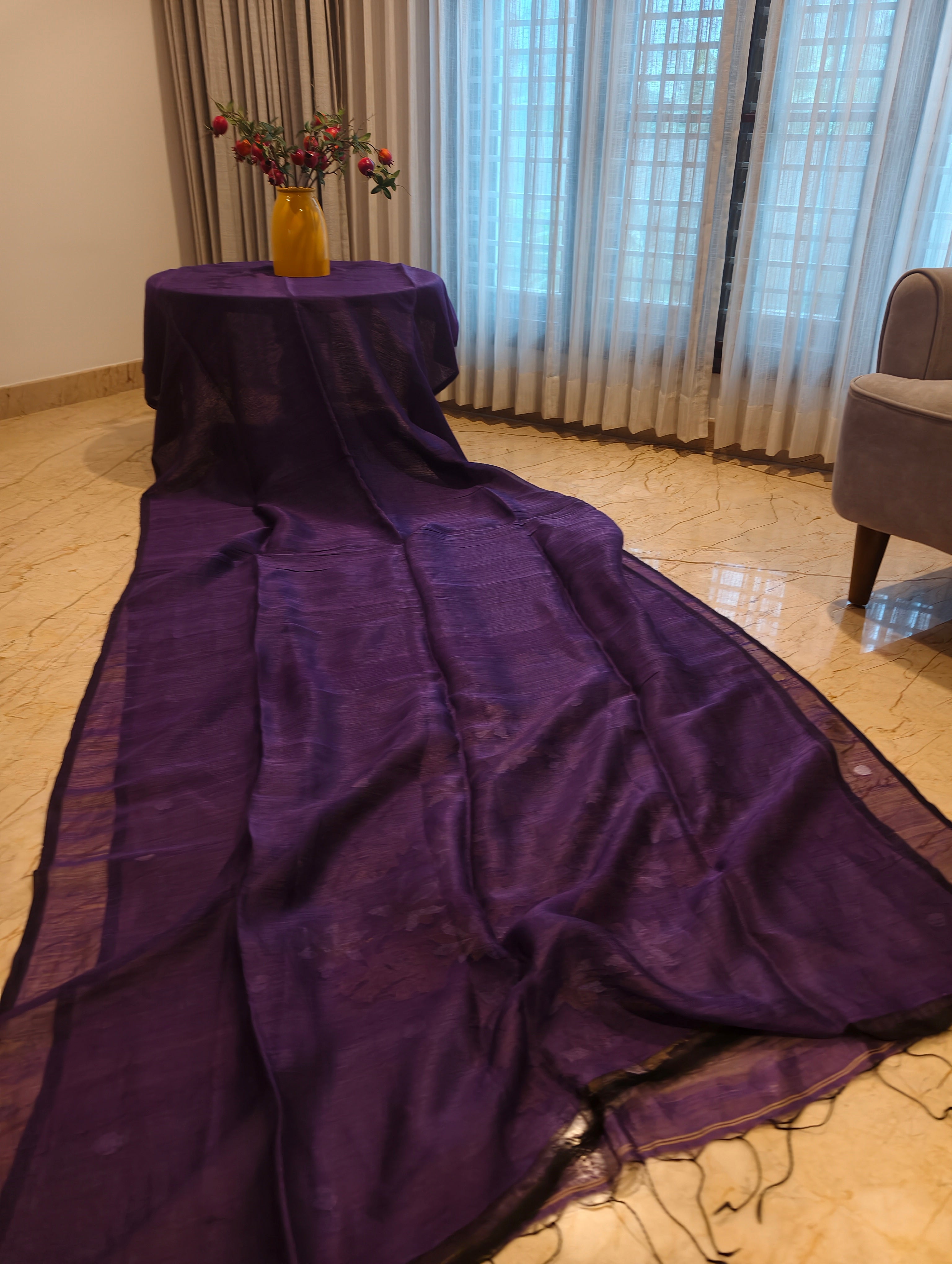 Full view of the purple Matka Muslin saree body with textured weave, border and tassels