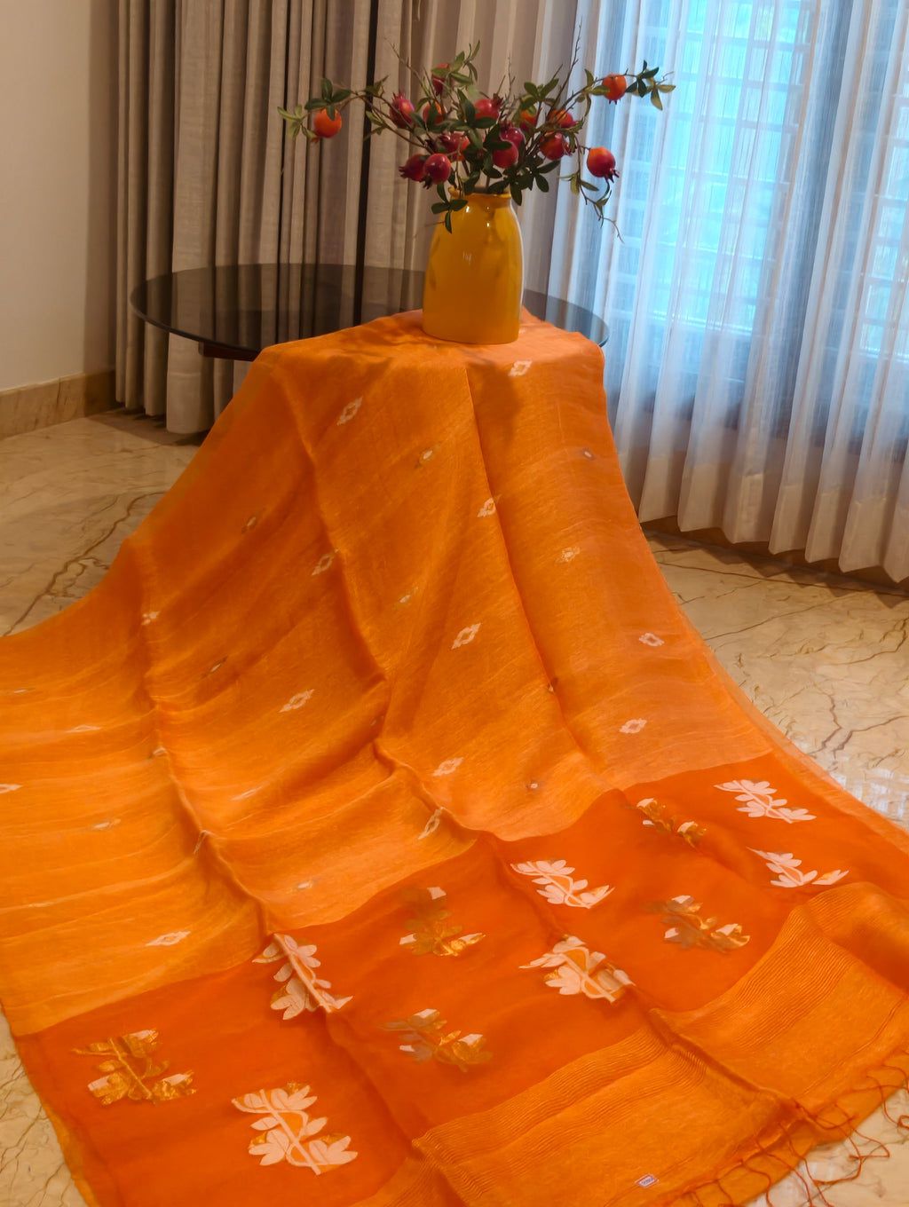 Orange Matka Muslin Jamdani saree with white and gold woven motifs and pallu