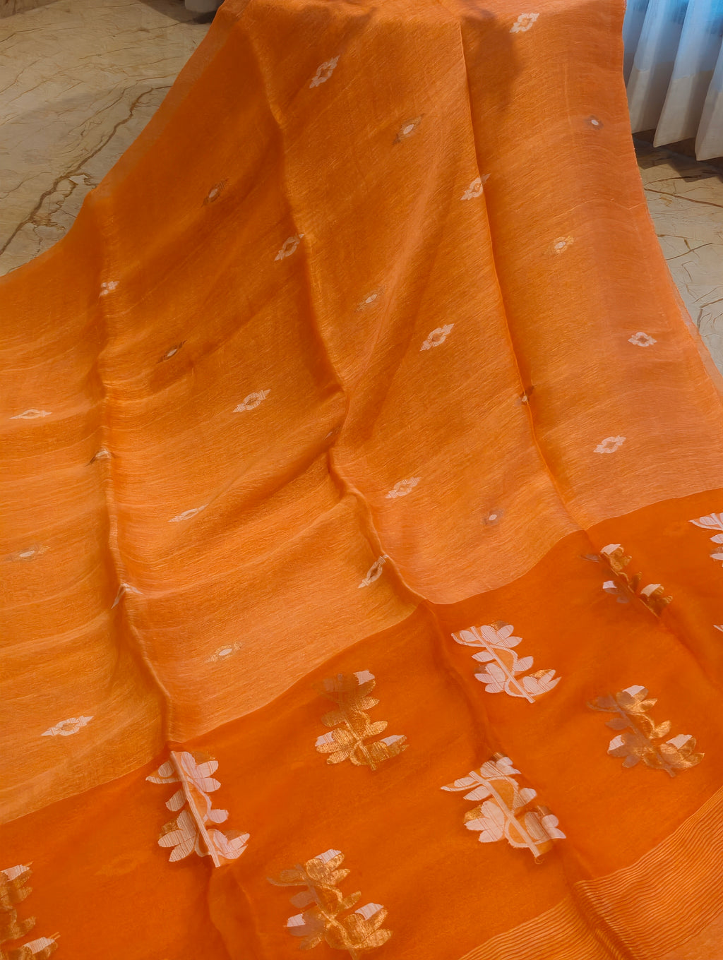 Orange Matka Muslin Jamdani saree with white and gold woven floral motifs