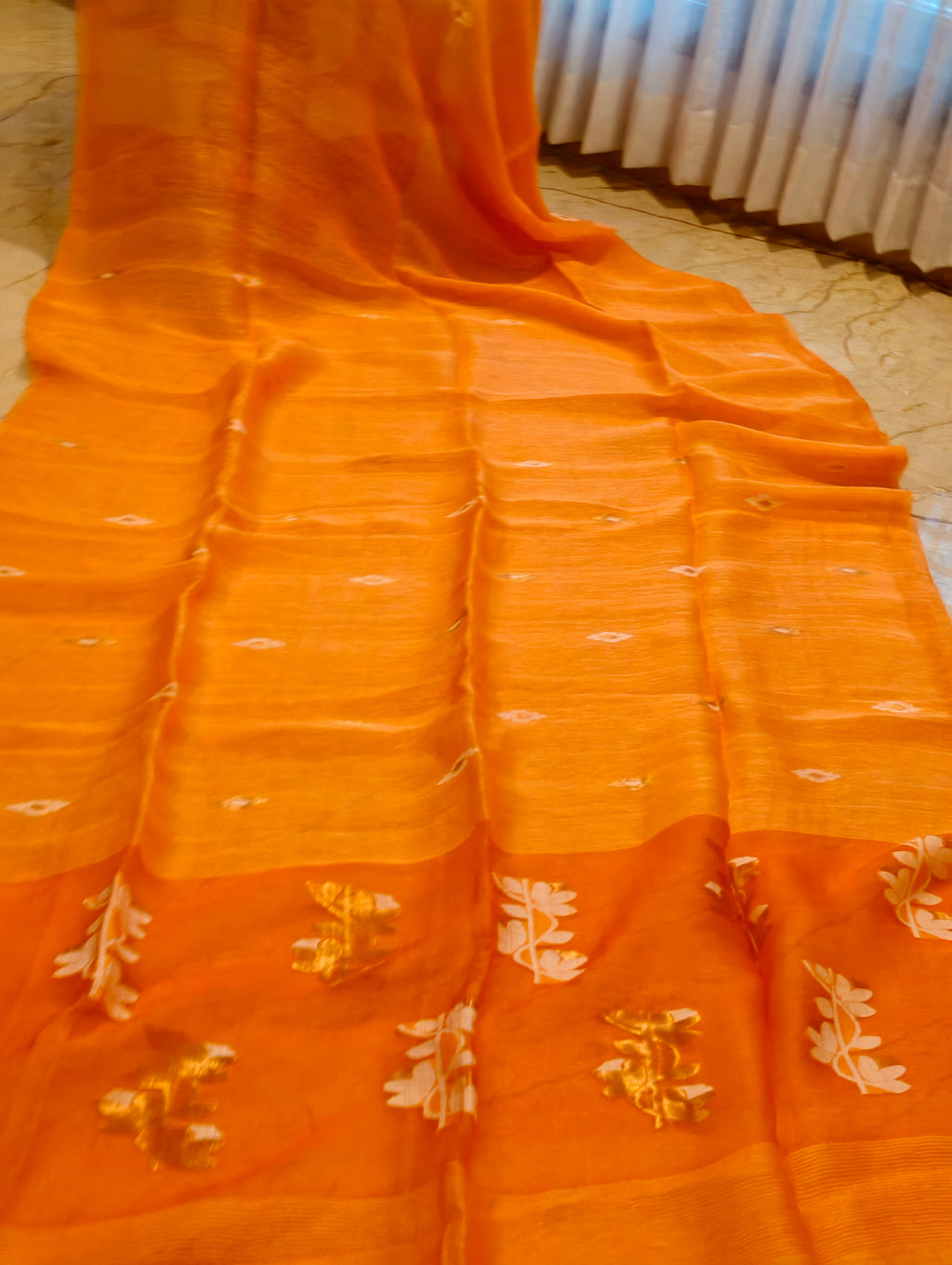 Orange Matka Muslin Jamdani saree with white and gold handwoven motifs