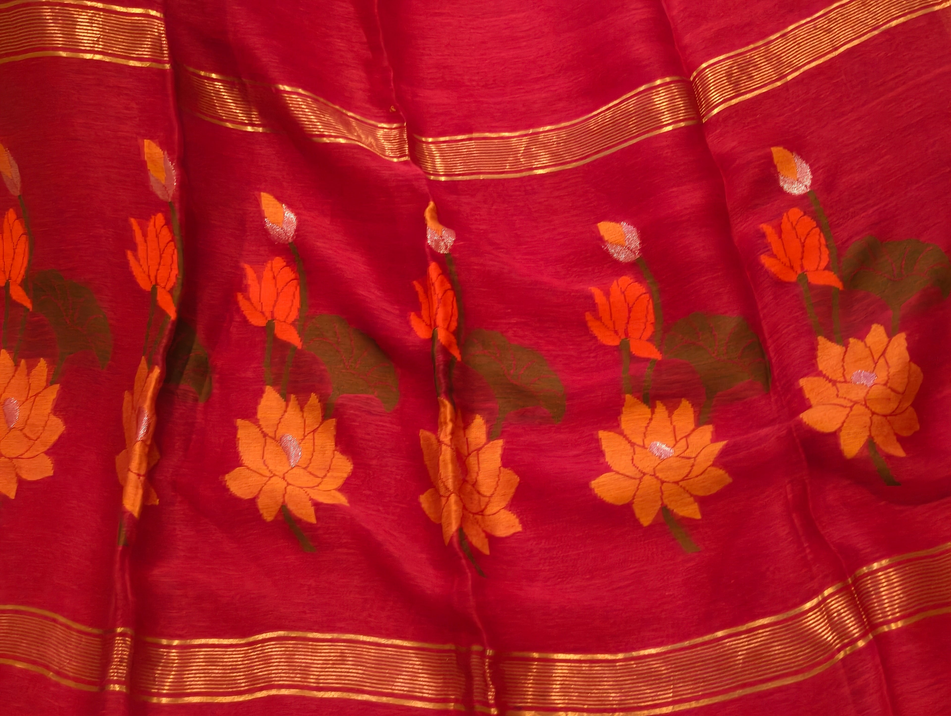 Dark pink Matka Silk Jamdani saree with lotus motifs and zari border close-up
