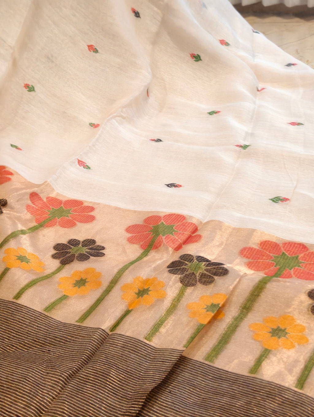 Close-up of white Matka silk Jamdani saree with colourful woven floral pallu and striped zari border – Nayikaa