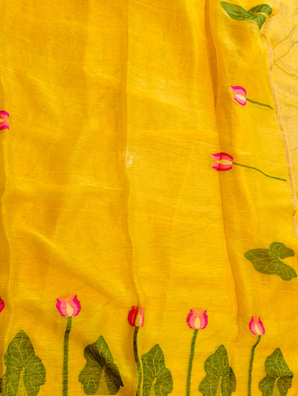 Yellow Matka silk Jamdani saree showing woven pink lotus flowers and green leaf border – Nayikaa
