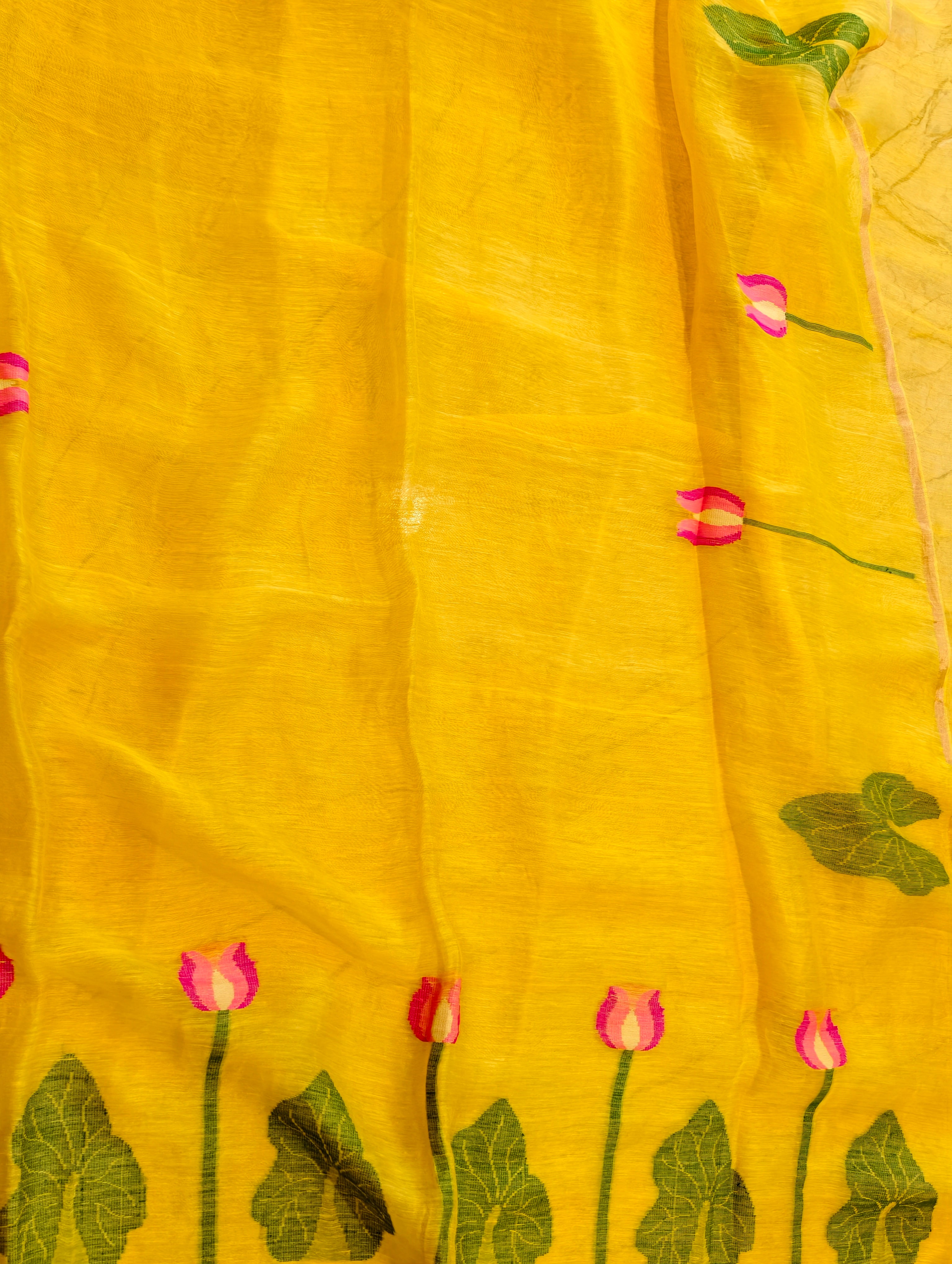 Yellow Matka silk Jamdani saree showing woven pink lotus flowers and green leaf border – Nayikaa